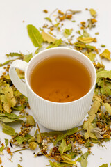 Winter Herbal tea isolated on a white background. Linden tea. immune-boosting herbal tea. Medicinal tea prepared from linden leaves, Clove particles and Chamomile.