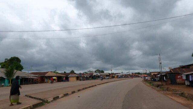 Sierra Leone rural village market town drive Africa POV. West Africa suffers with extreme poverty and hunger. Tropical climate. Transportation limited due to bad roads and infrastructure.