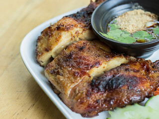 Roast chicken legs on Dish plate with spicy Dipping Sauce