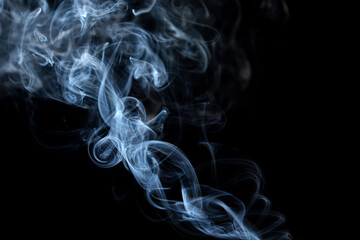 Twisted plumes of smoke, smoke movement on a black background. Abstract smoke lines