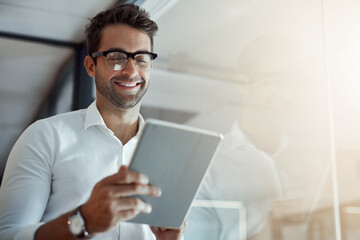 Business is all about attitude. Cropped shot of a handsome young businessman working on his digital...