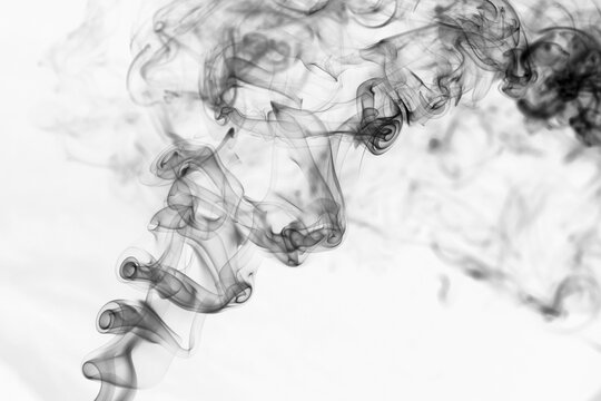 Twisted plumes of smoke, movement of black smoke on a white background. Abstract smoke lines