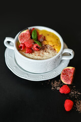 Breakfast oat porridge with berries and mango jam