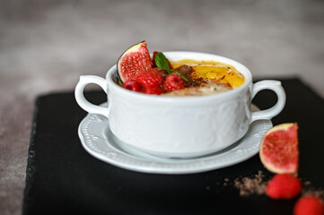 Breakfast oat porridge with berries and mango jam