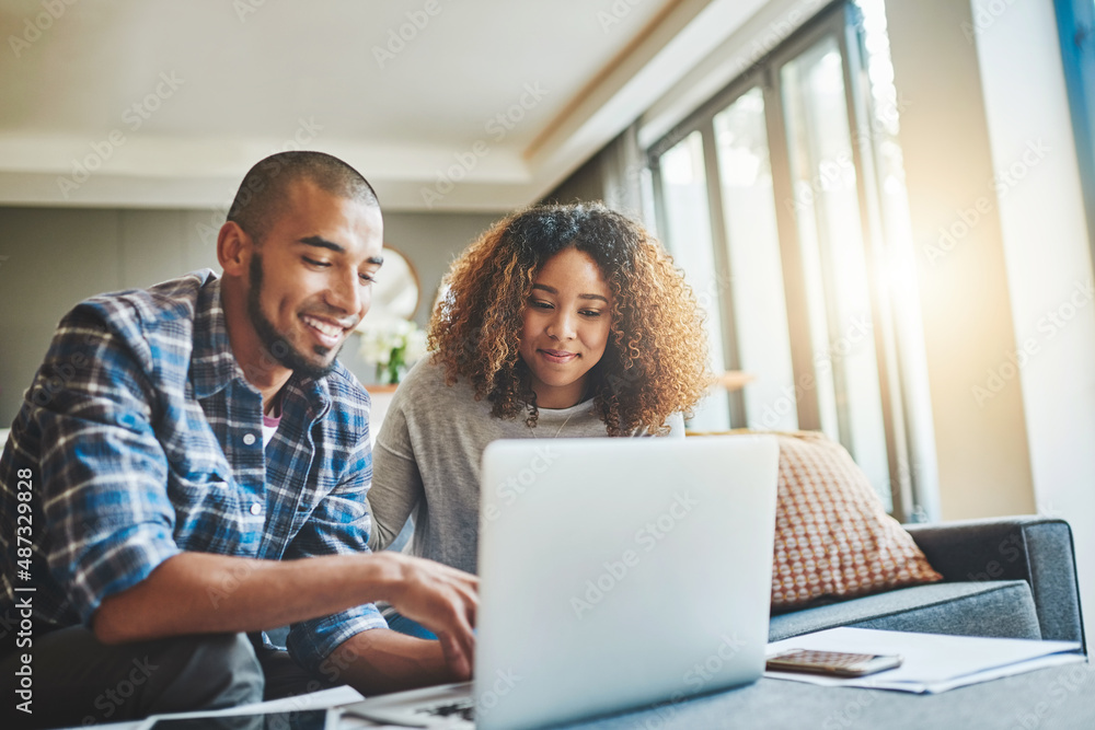 Aufkleber managing money matters with wireless technology. shot of a young couple using a laptop while working