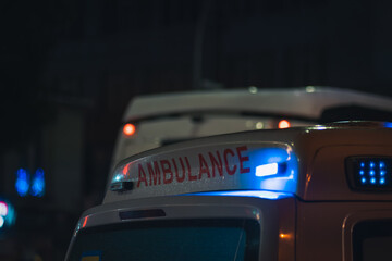 Obraz na płótnie Canvas Close-up of an ambulance with lights at night, copy space