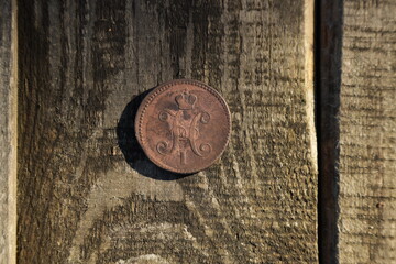 Old coin of Russian Empire on wooden table
