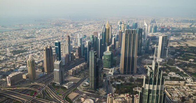 Panoramic view of Dubai skyline from Burj Khalifa tower skyscraper. Time lapse