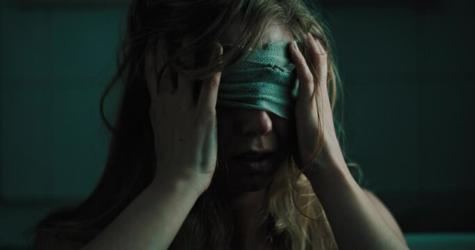 confused female adult with bandage on eyes hides from social anxiety