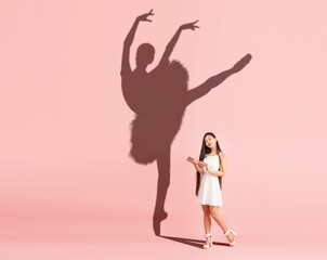 Young asian girl dreams of becoming a ballet dancer isolated on pink background. Sport, career and dreams concept. Collage