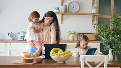 A Busy Annoyed Mother Trying to Work Remotely Calming Her Crying A Little Daughter, Another...