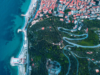 Aerial view of Noli, a beautiful small village in Liguria, north Italy. Drone photography of the Ligurian coast, province of Savona, near Spotorno and Bergeggi. Birds eye of Capo Noli and Monte Ursino