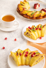 Cheesecake with cup of tea on gray concrete background and orange textile, side view, selective focus.