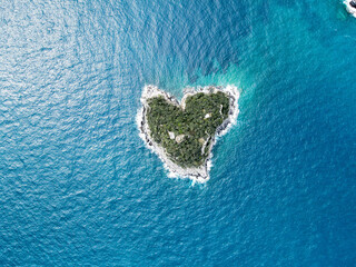 Aerial view of Bergeggi island, heart island from above, in Liguria, north Italy. Drone photography of the Ligurian coast, province of Savona with Spotorno and the island of Bergeggi.