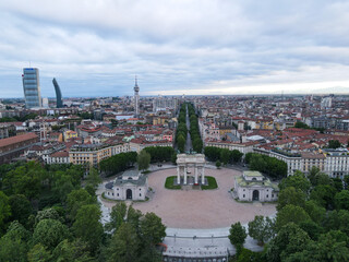 Fototapeta na wymiar Aerial view of Arco della Pace in Milano, north Italy. Drone photography of Arch of Peace in Piazza Sempione, near Sempione park in the heart of Milan, Lombardy and Sforza Castle.