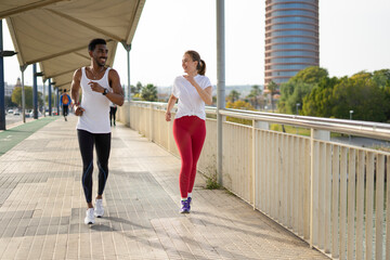 Obraz premium two interracial people running on the street