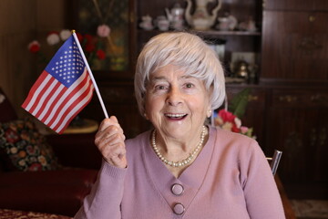 Senior woman waving North American flag