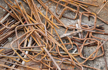 Rusty twisted metal rods bars or rebars. Background construction building industry materials.