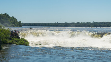 Tourists admiring the Devil's Throat waterfall at the Iguazu National Park in Puerto Iguazu, Argentina