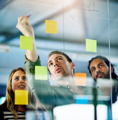 Combining knowledge for the good of business. Shot of colleagues having a brainstorming session...