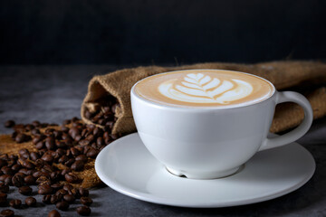 Top view of green hot cappuccino cup With milk foam on wooden board background.