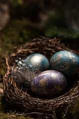 Happy Easter 2022. A postcard with a copy of the place for the text. Purple, blue and golden eggs in a nest on a natural forest background. Top view.