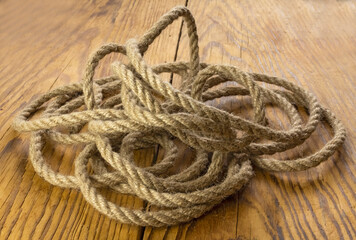 Fototapeta na wymiar Brown nautical strong rope on the table close-up