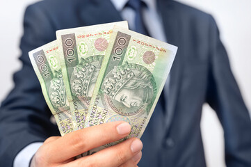 Range of Polish banknotes in businessman hand
