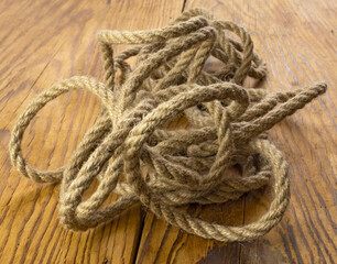 Fototapeta na wymiar Brown nautical strong rope on the table close-up
