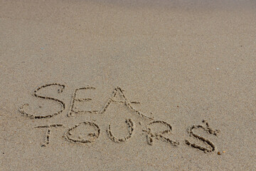 Season of travel. sea tour. Summer trips to the sea. Concept of leisure and travel. inscription sea on the wet sand of the coast