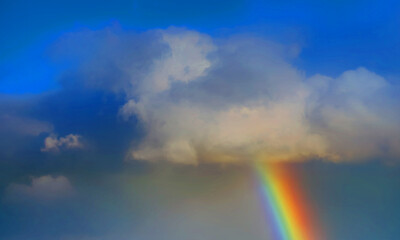 Fototapeta na wymiar rainbow sky with some white clouds surface abstract flow thunder clouds in the light blue sky.