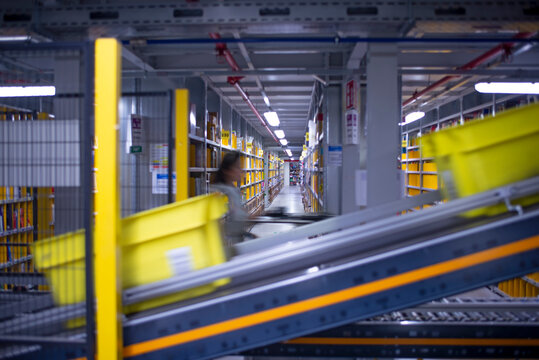 interior of logistic warehouse with a worker walking