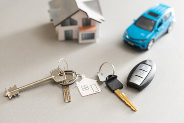 car and house model for sale with money, key on background, house for sale concept, closeup.
