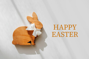 Happy Easter card. Wooden Easter Bunny on white background. Holiday concept.