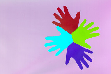 Abstract background open colored paper palms on a colored background.