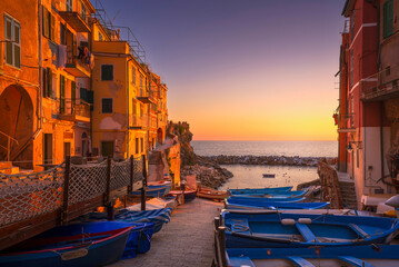 Riomaggiore village street, boats and sea at sunset. Cinque Terre, Ligury, Italy.
