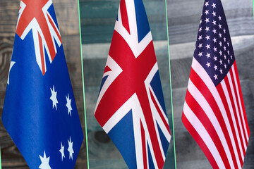 Collage of flags of Australia, the United Kingdom and the United States. AUKUS Alliance from Australia, UK, USA