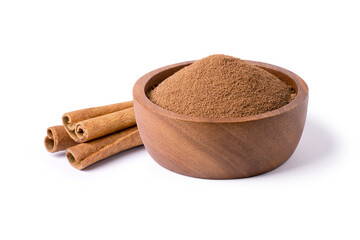 Cinnamon powder in wooden bowl with cinnamon sticks isolated on white background.