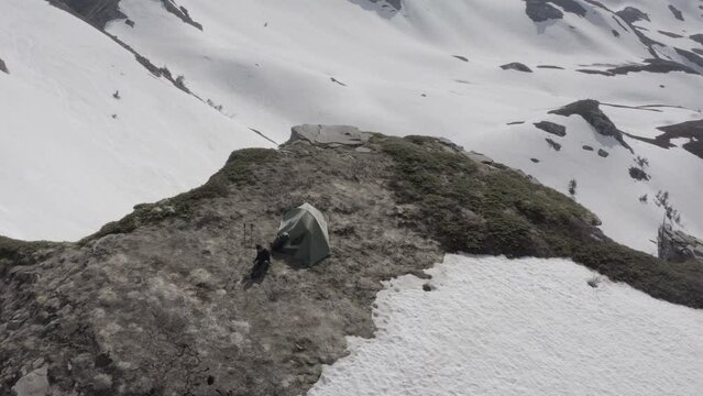 Wild camping bivouac on top of snowy mountains