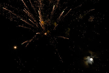 Fireworks in the night sky with moon.