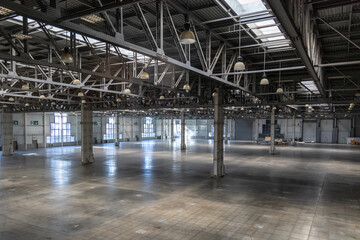Spacious empty pavilion for exhibitions and fairs. Hangar, a place intended for storage of large-sized objects. Modern large warehouse or storage