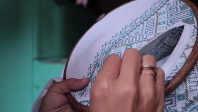 Hands embroider Ukrainian national vyshyvanka