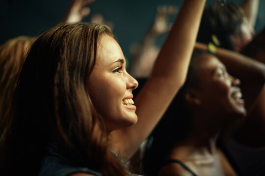 Young girls in an audience enjoying their favorite bands performance. This concert was created for the sole purpose of this photo shoot, featuring 300 models and 3 live bands. All people in this shoot