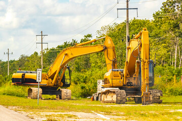 Excavators and other industrial vehicles destroy the jungle Tulum Mexico.