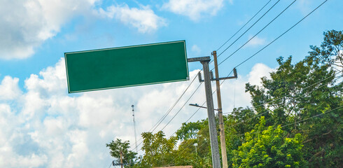 Directional green blank empty road sign in Tulum Mexico.