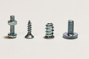 four different screws positioned vertically on a white background
