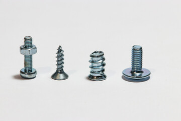 four different screws positioned vertically on a white background
