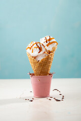 Ice cream scoops gelato in cone blue background - 487353804