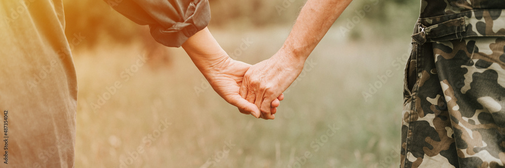 Wall mural happy senior couple holding hands. hands of man and woman hold each other. romance and love and supp