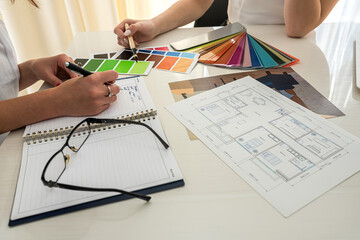 young business ladies working in the office with panoramic windows over new apartment design.